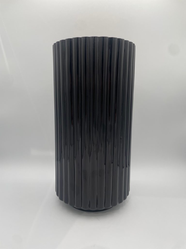 Modern ribbed glass vase in black minimalist table decor on neutral background White ribbed glass vase modern home decor accent for shelf or table styling